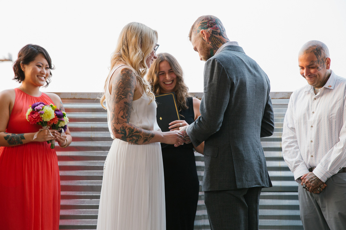 Within Sodo Seattle wedding ceremony bride groom rings