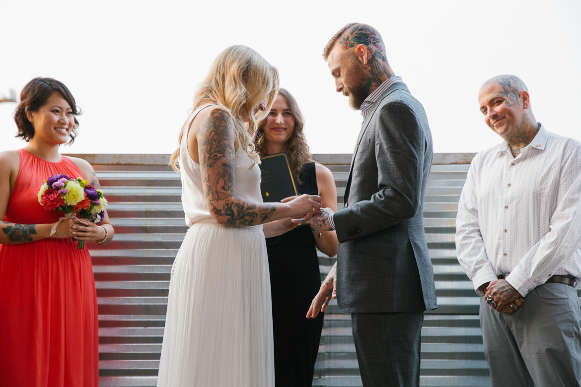 Within Sodo Seattle wedding ceremony bride groom rings
