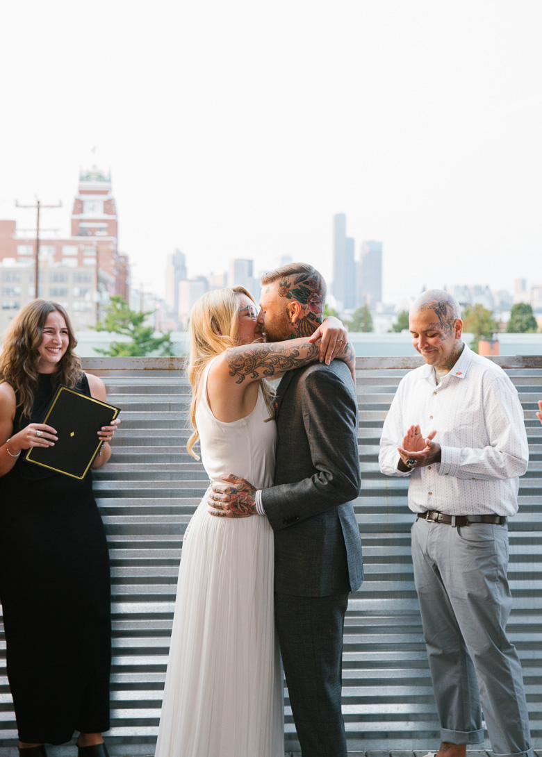 Within Sodo Seattle wedding ceremony bride groom kiss