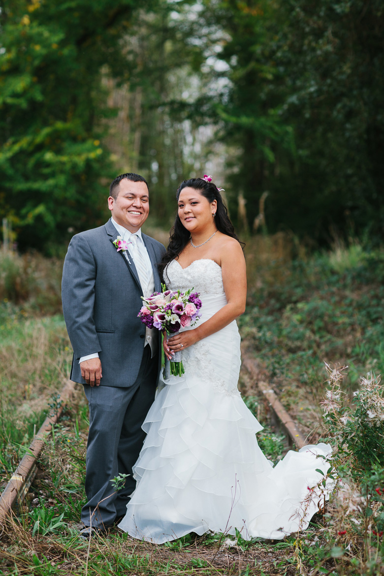 Bride and groom on abandoned railroad track during Columbia Winery wedding in Woodinville