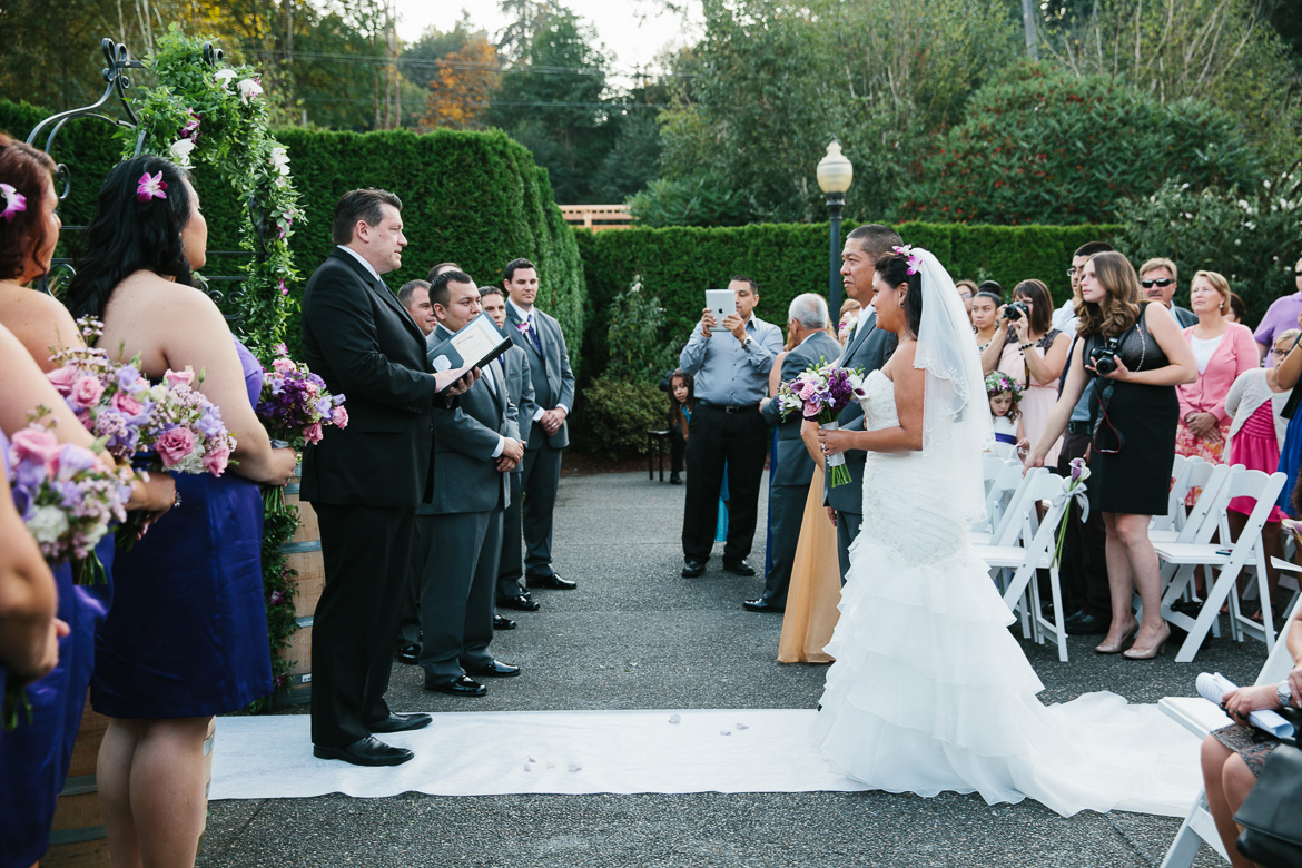 Bride walking down aisle during Columbia Winery wedding ceremony in Woodinville
