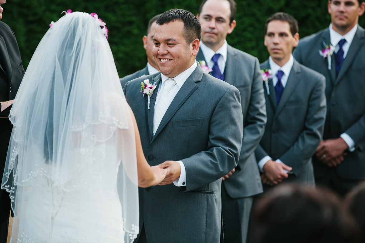 Groom during ceremony at Columbia Winery wedding in Woodinville