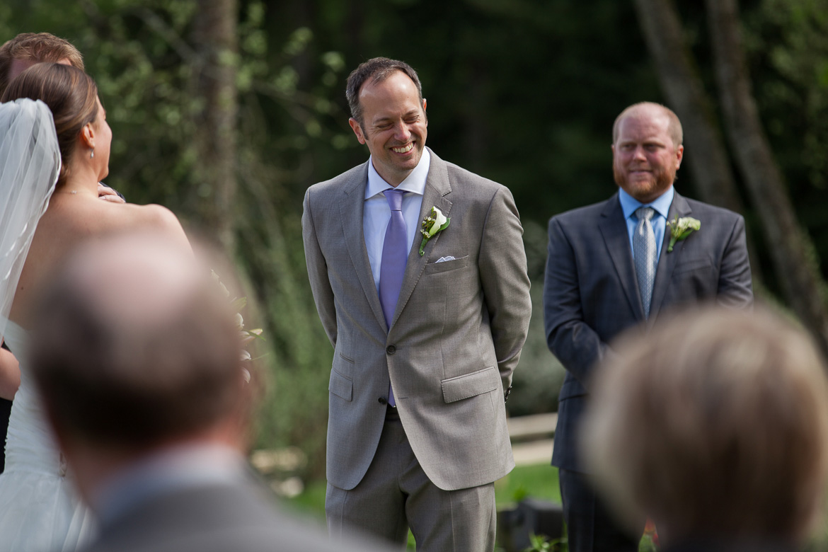 Groom laughing during wedding ceremony at Fireseed Catering on Whidbey Island. WA