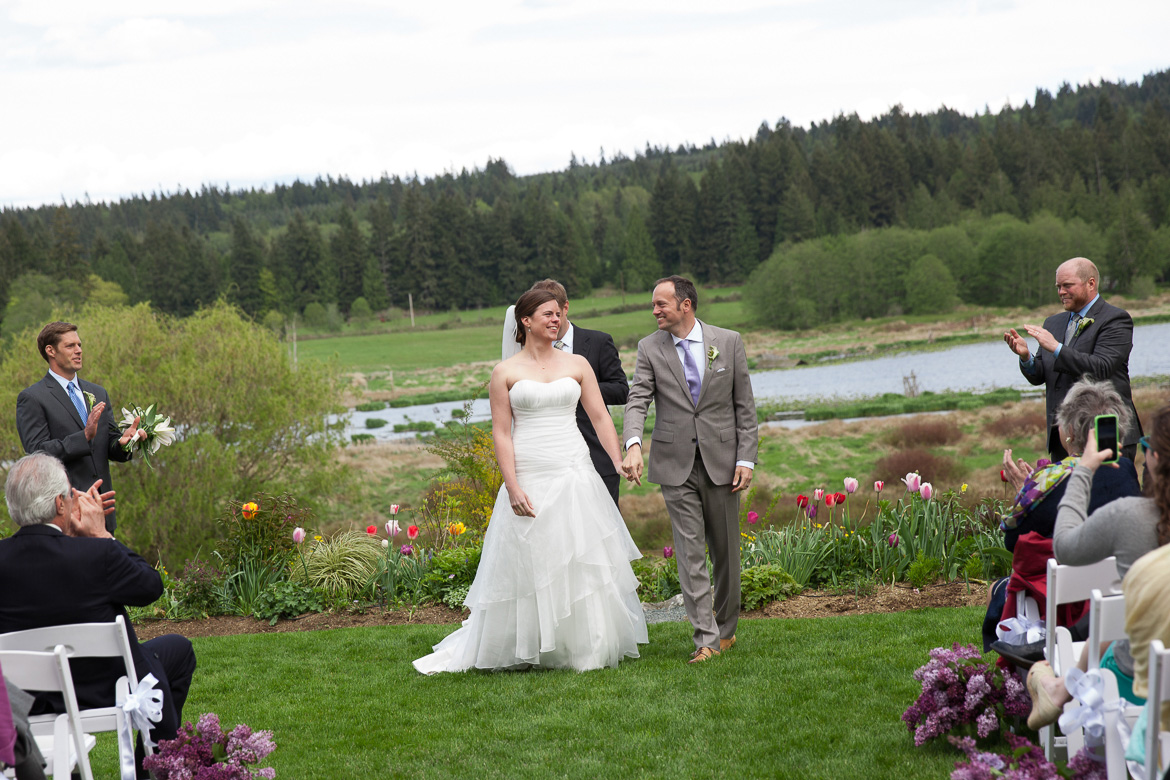 Bride and groom walking down aisle wedding ceremony at Fireseed Catering on Whidbey Island. WA