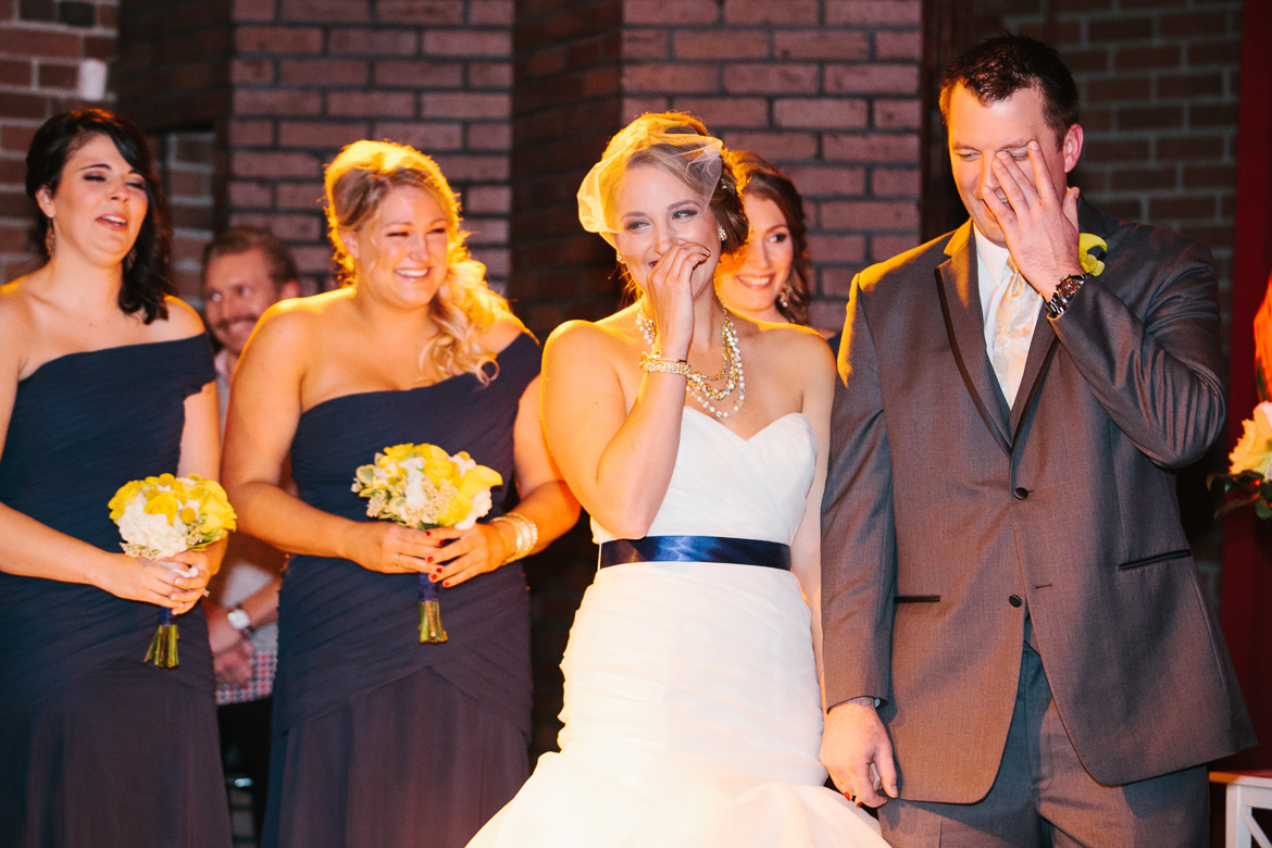 Bride and groom laughing during wedding ceremony at Georgetown Ballroom in Seattle, WA