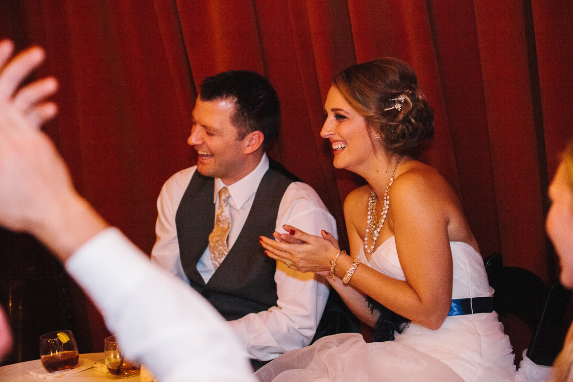 Bride and groom laughing during toasts at Georgetown Ballroom wedding in Seattle, WA