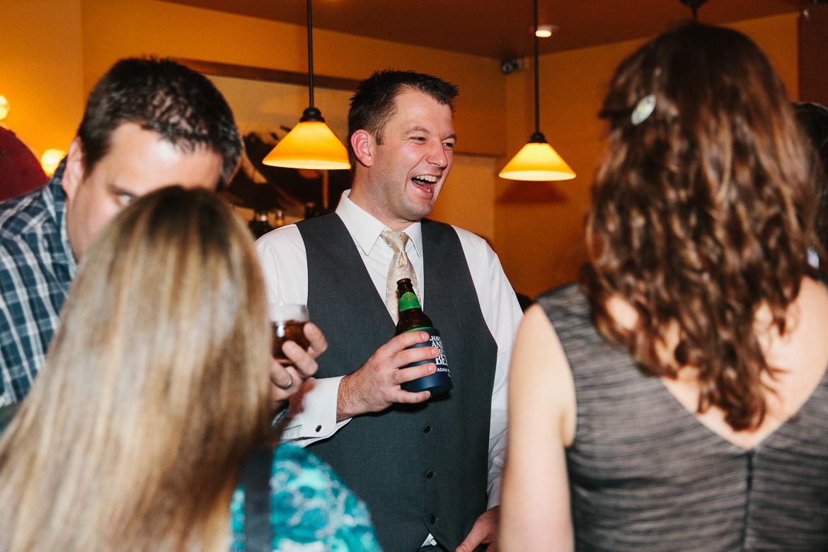 Groom laughing during reception at Georgetown Ballroom wedding in Seattle, WA