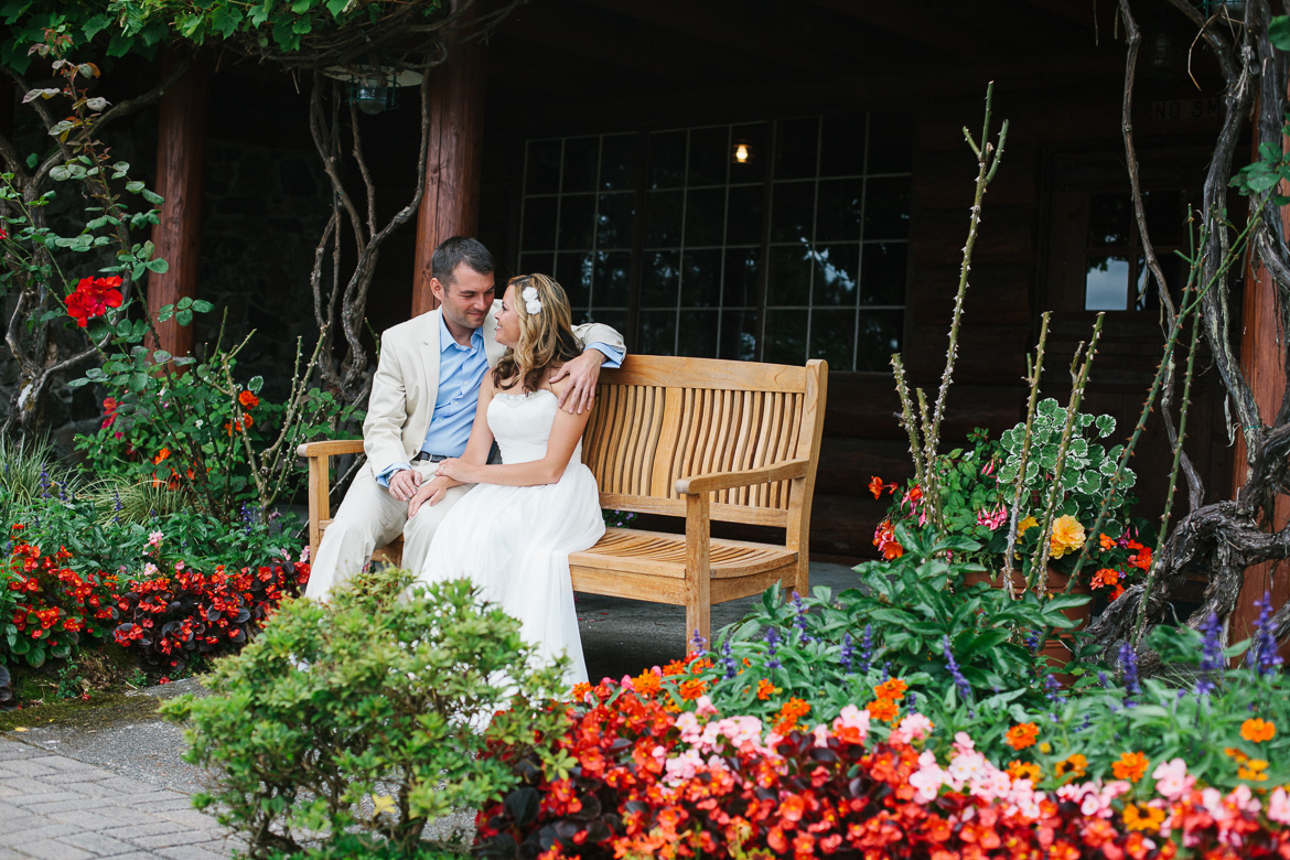 Bride and groom on bench before wedding at Kiana Lodge in Poulsbo, WA
