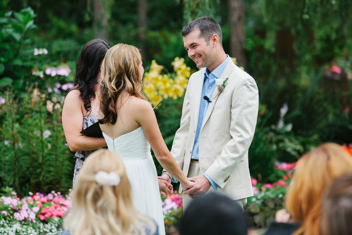 Groom laughing during wedding ceremony at Kiana Lodge in Poulsbo, WA