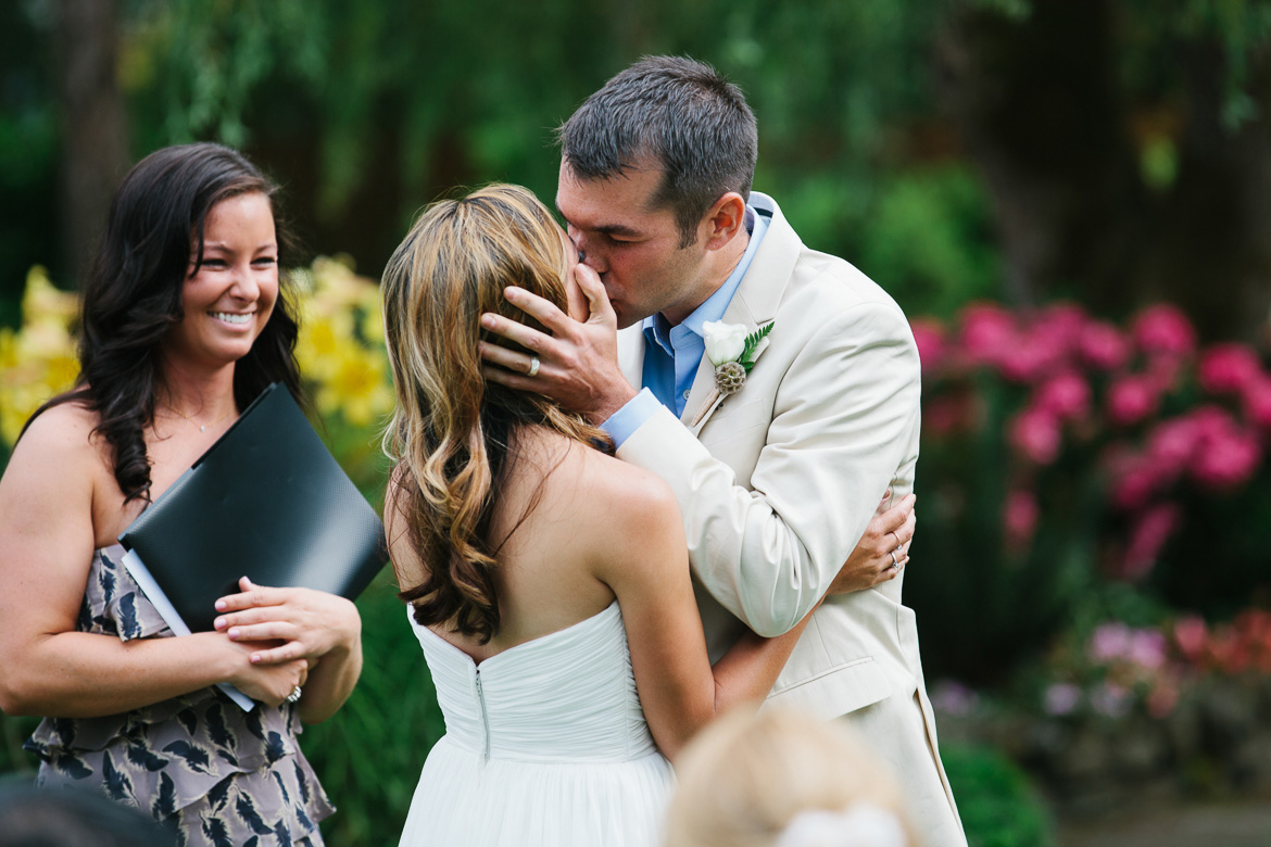 Bride and groom's first kiss during wedding at Kiana Lodge in Poulsbo, WA