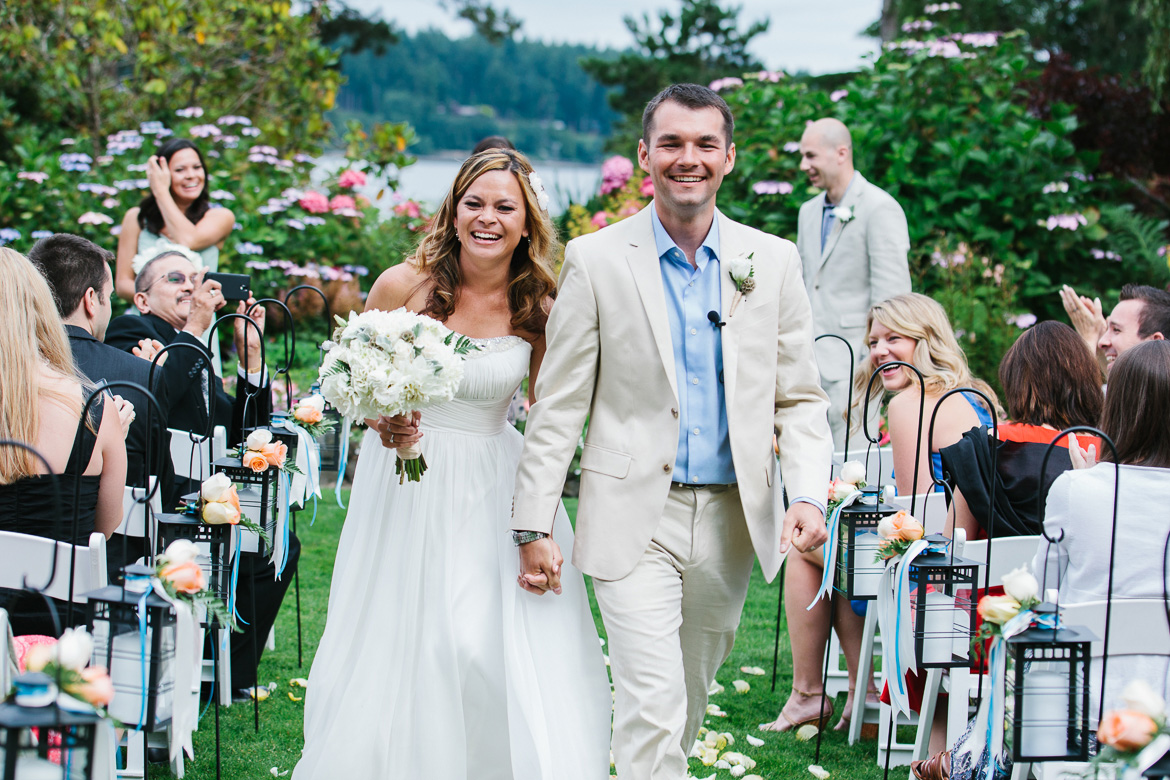 Bride and groom walking down aisle after wedding ceremony at Kiana Lodge in Poulsbo, WA