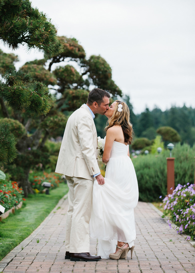 Bride and groom kissing before wedding at Kiana Lodge in Poulsbo, WA