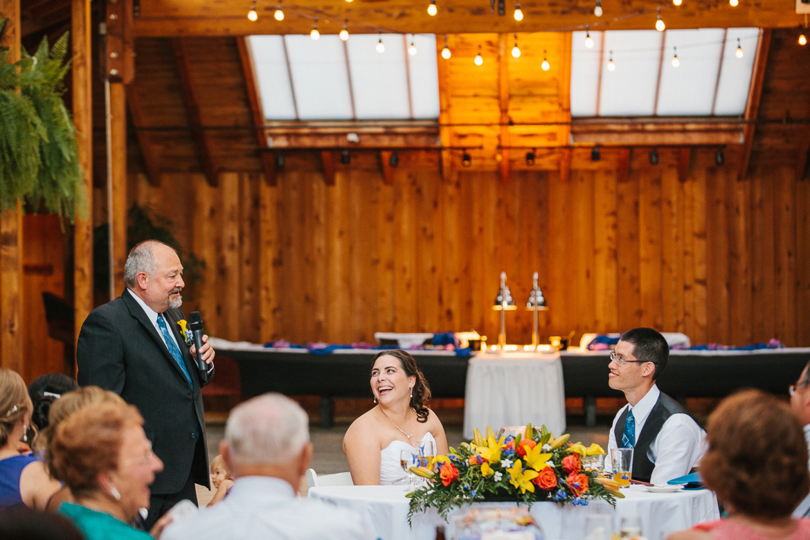 Bride and groom laughing during reception toasts at Kiana Lodge wedding in Poulsbo, WA