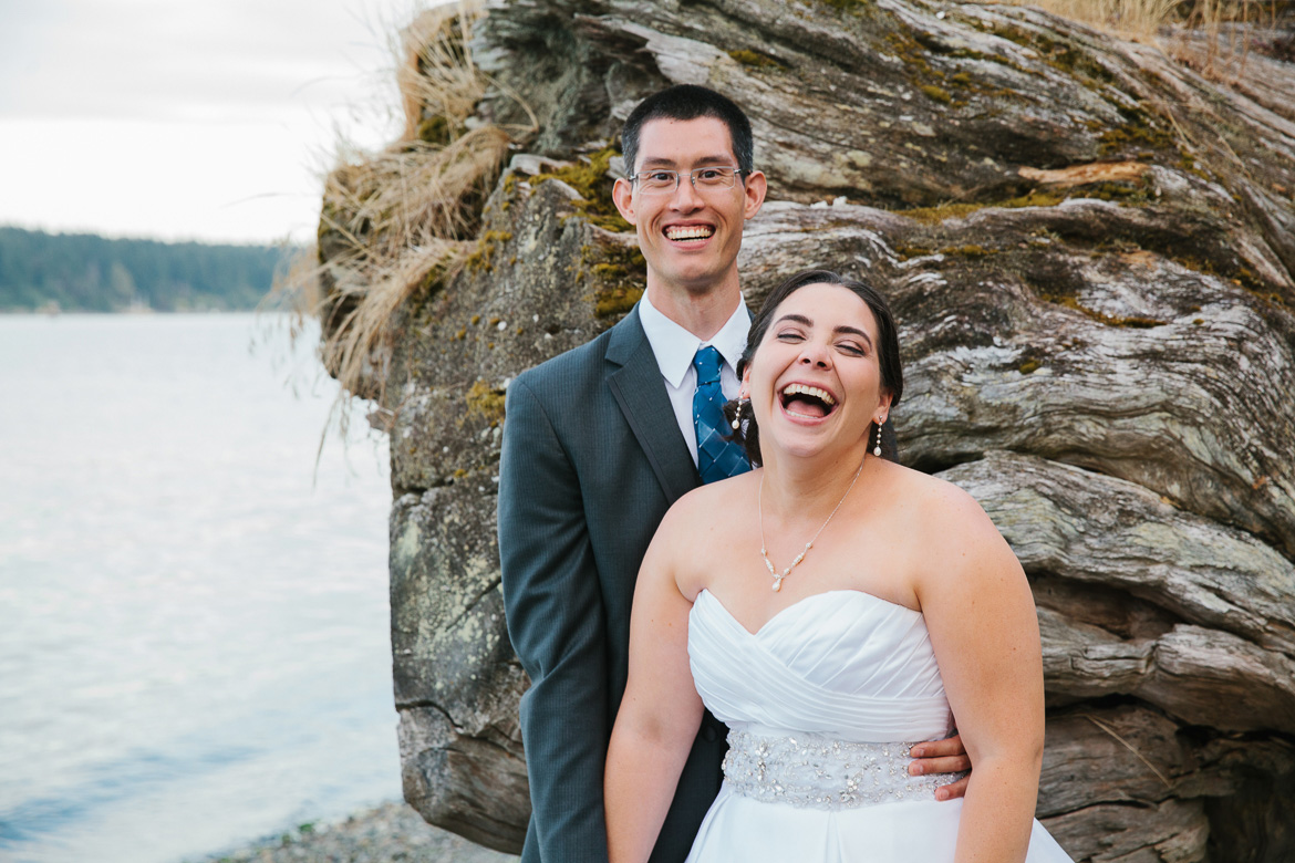 Bride and groom laughing during sunset portrait at Kiana Lodge wedding in Poulsbo, WA