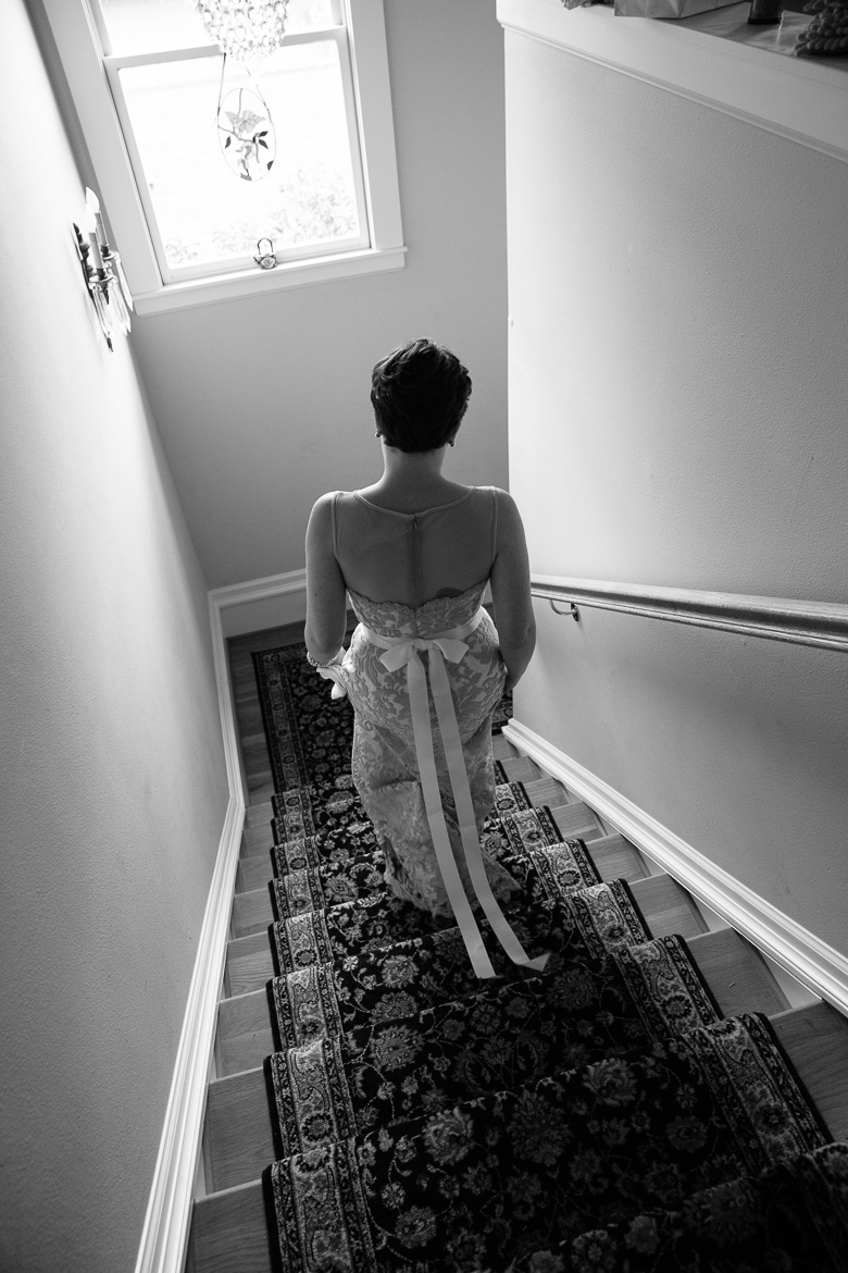 Bride descending stairs before her autumn wedding in Seattle, WA
