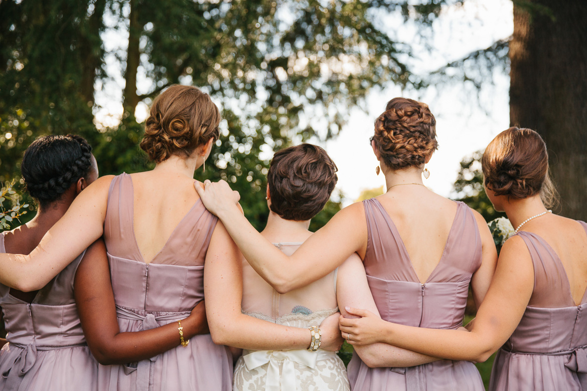 Bride and bridesmaids during portraits at Volunteer Park in Seattle, WA during wedding photography coverage