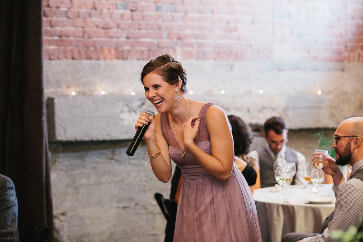 Bridesmaid giving toast during reception at Melrose Market Studios wedding in Seattle, WA