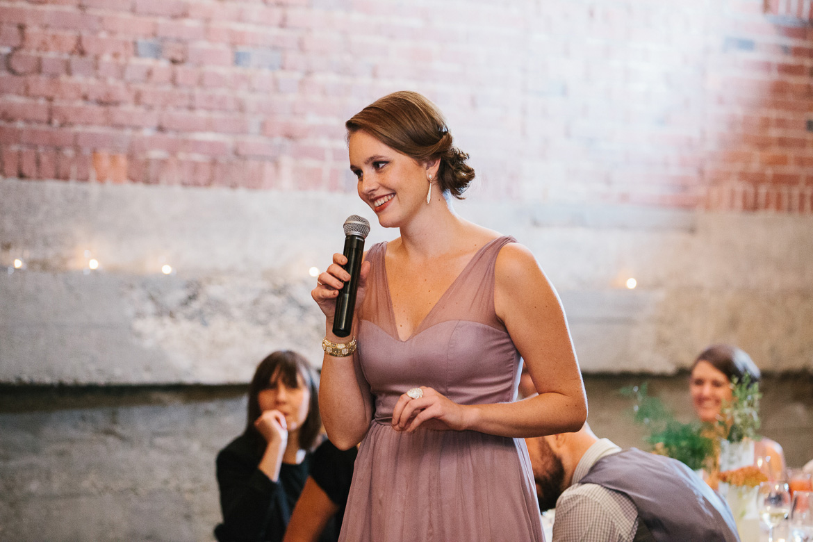 Maid of honor giving toast during reception at Melrose Market Studios wedding in Seattle, WA
