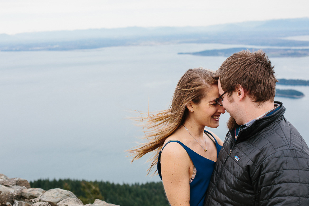 Windy engagement photo session on Mt Constitution with views of San Juan Islands