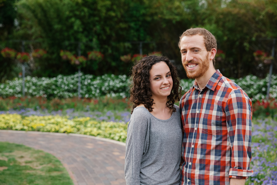 Couple at Lake Eola Park during engagement session near flowers