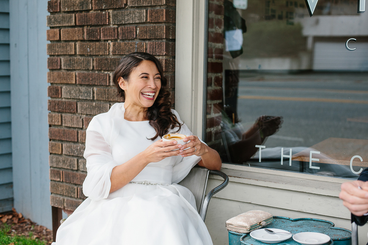 Bride laughing and drinking coffee at Victrola Coffee on Beacon Hill Seattle
