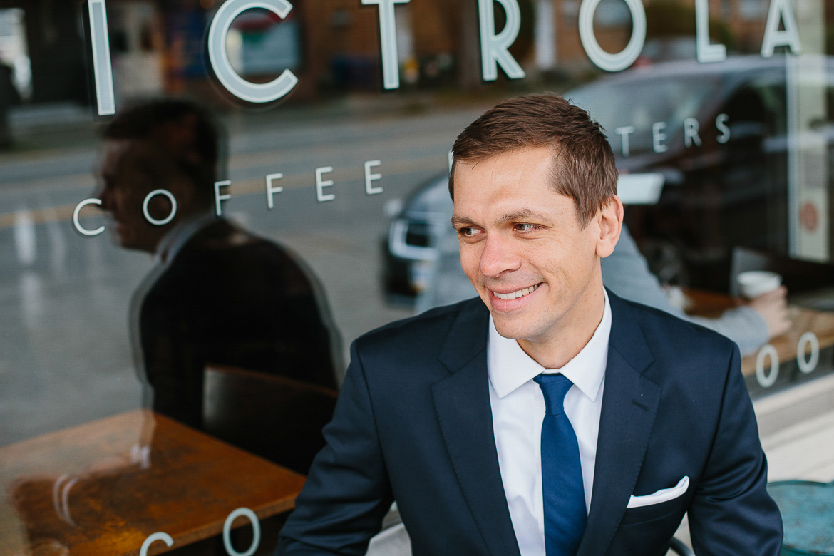 Groom laughing at Victrola Coffee on Beacon Hill Seattle