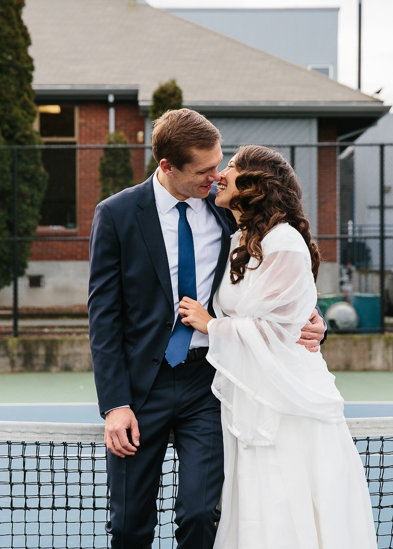 Bride and groom on tennis court before downtown Seattle elopement