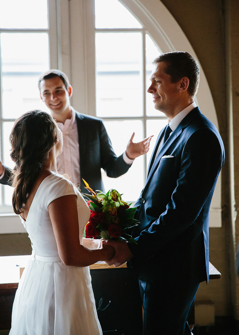 Bride, groom and officiant during elopement ceremony in Pike Place Market