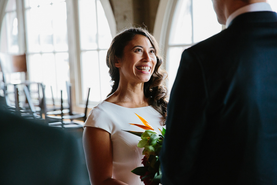 Bride smiling during elopement ceremony in Pike Place Market