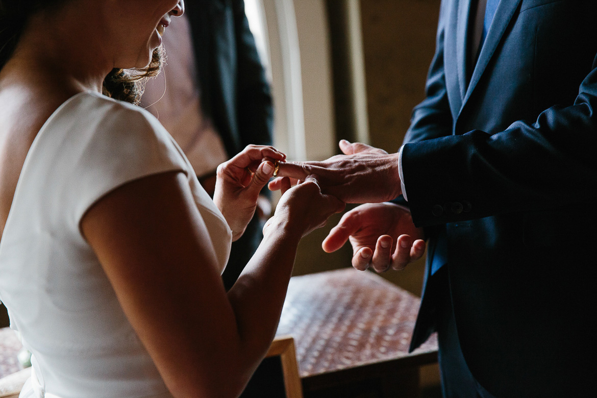 Exchanging rings during a Pike Place Market elopement in Seattle, Washington