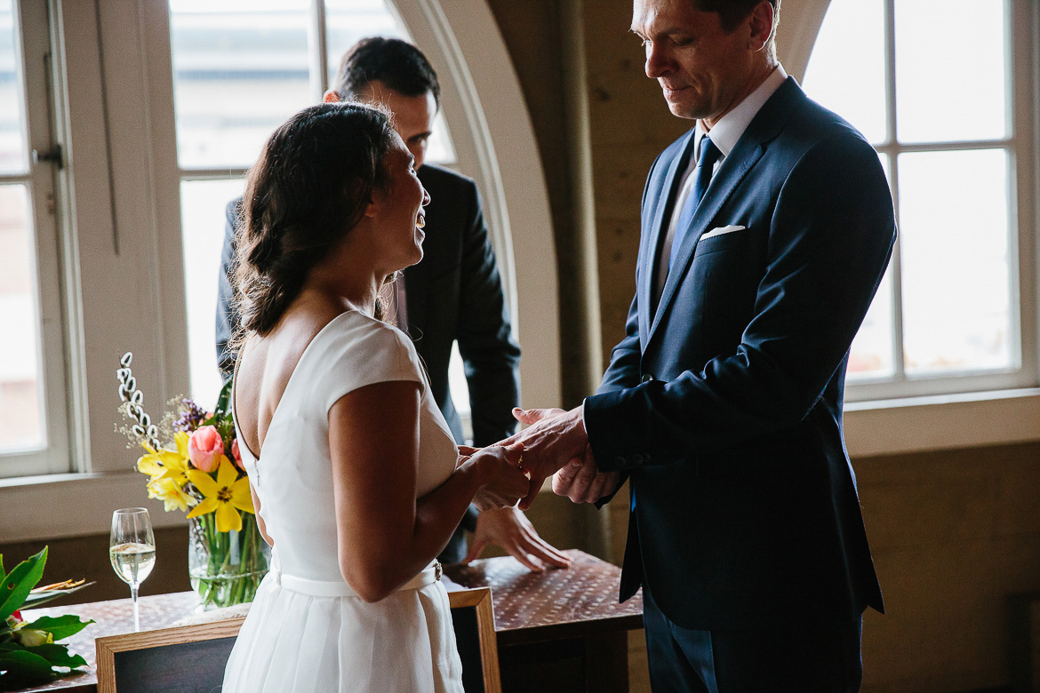 Bride and groom during ring exchange for a Pike Place Market elopement in Seattle, WA