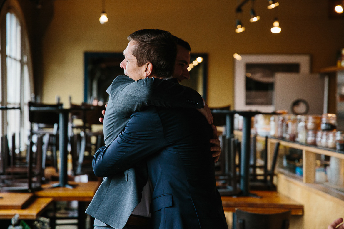 Groom and officiant share a hug after elopement ceremony in Seattle, WA