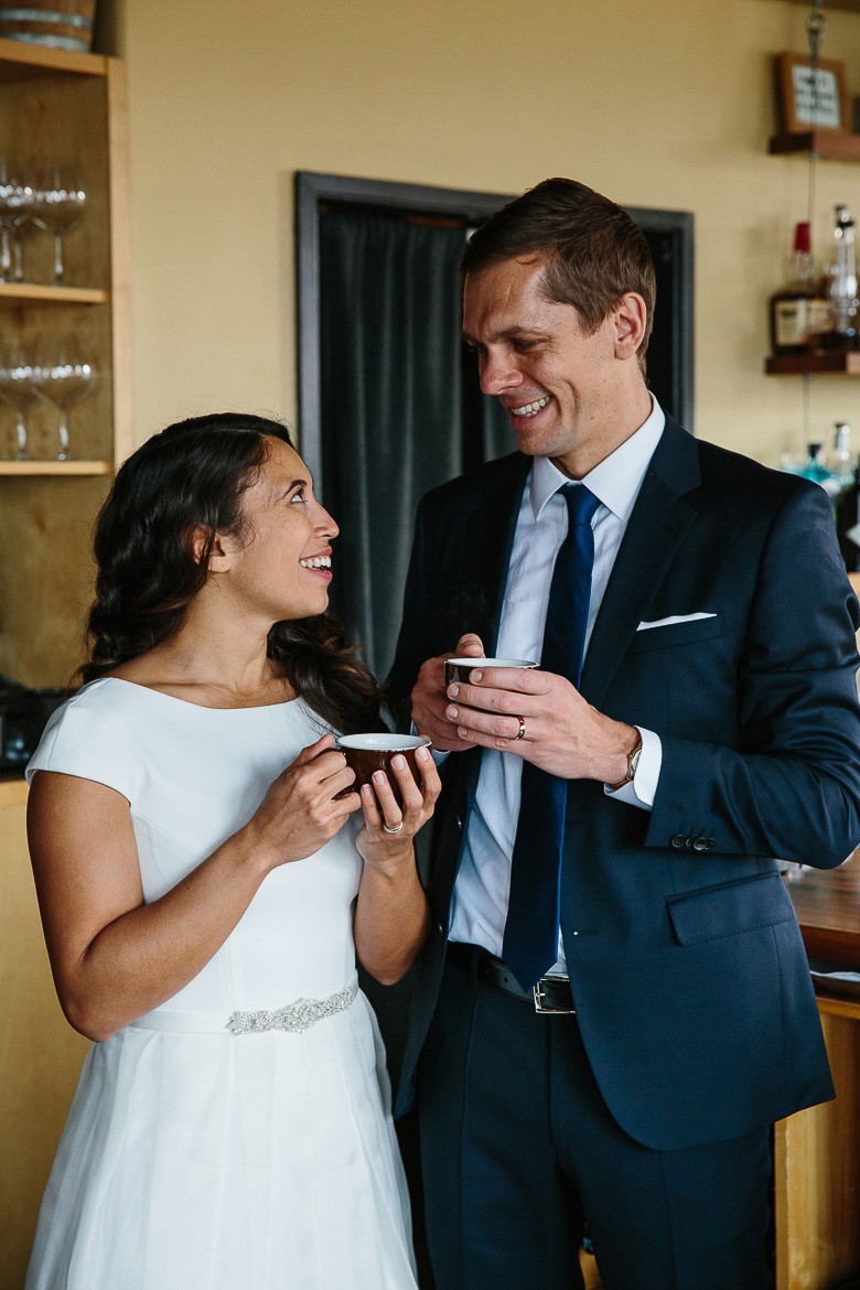 Bride and groom drinking coffee post elopement ceremony