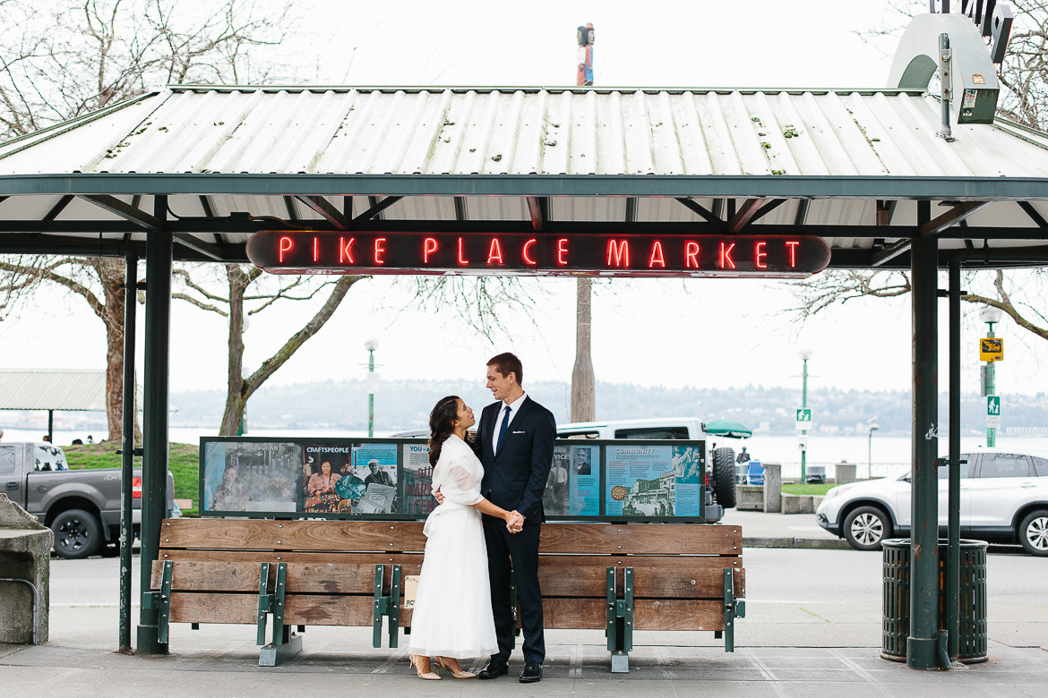 Bride and groom at Pike Place Market during elopement portrait session