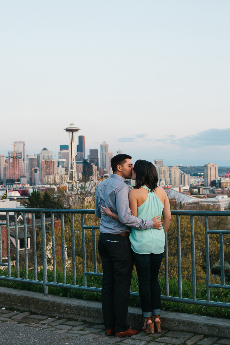 Seattle couple during sunset photo session on Upper Queen Anne at Kerry Park with city skyline