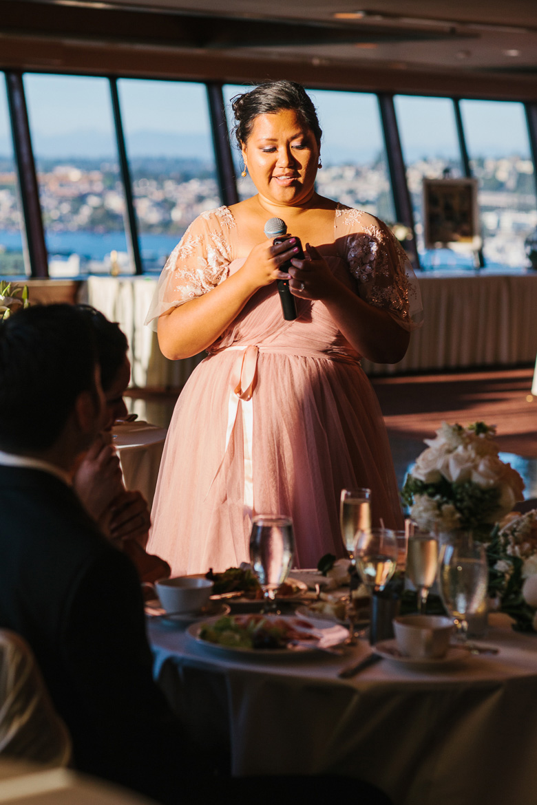 Bridesmaid during toasts at wedding reception at the Space Needle in Seattle, WA