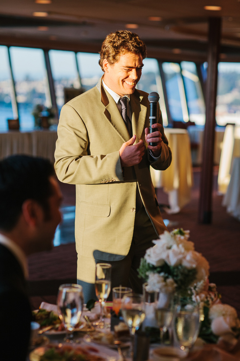 Groomsman during toasts at wedding reception at the Space Needle in Seattle, WA