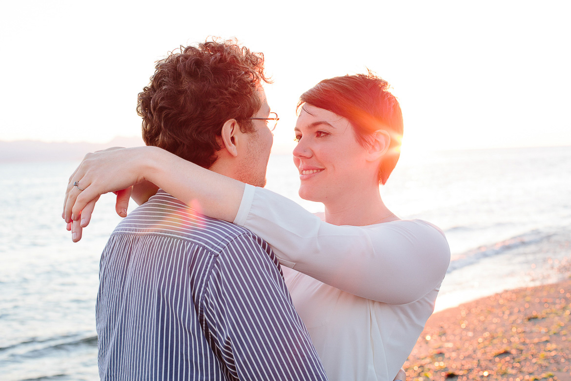 Couple standing on beach during engagement session on Whidbey Island