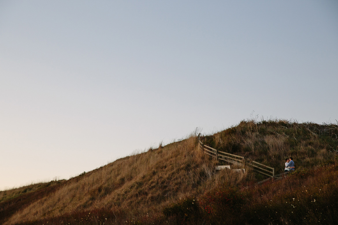 Couple on bluffs during a Whidbey Island sunset for engagement photos